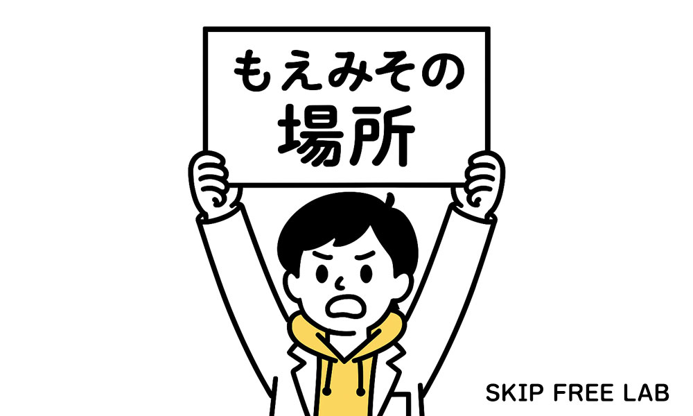 “もえみその場所”と書かれたボードを掲げるもえみそ(怒り顔)
